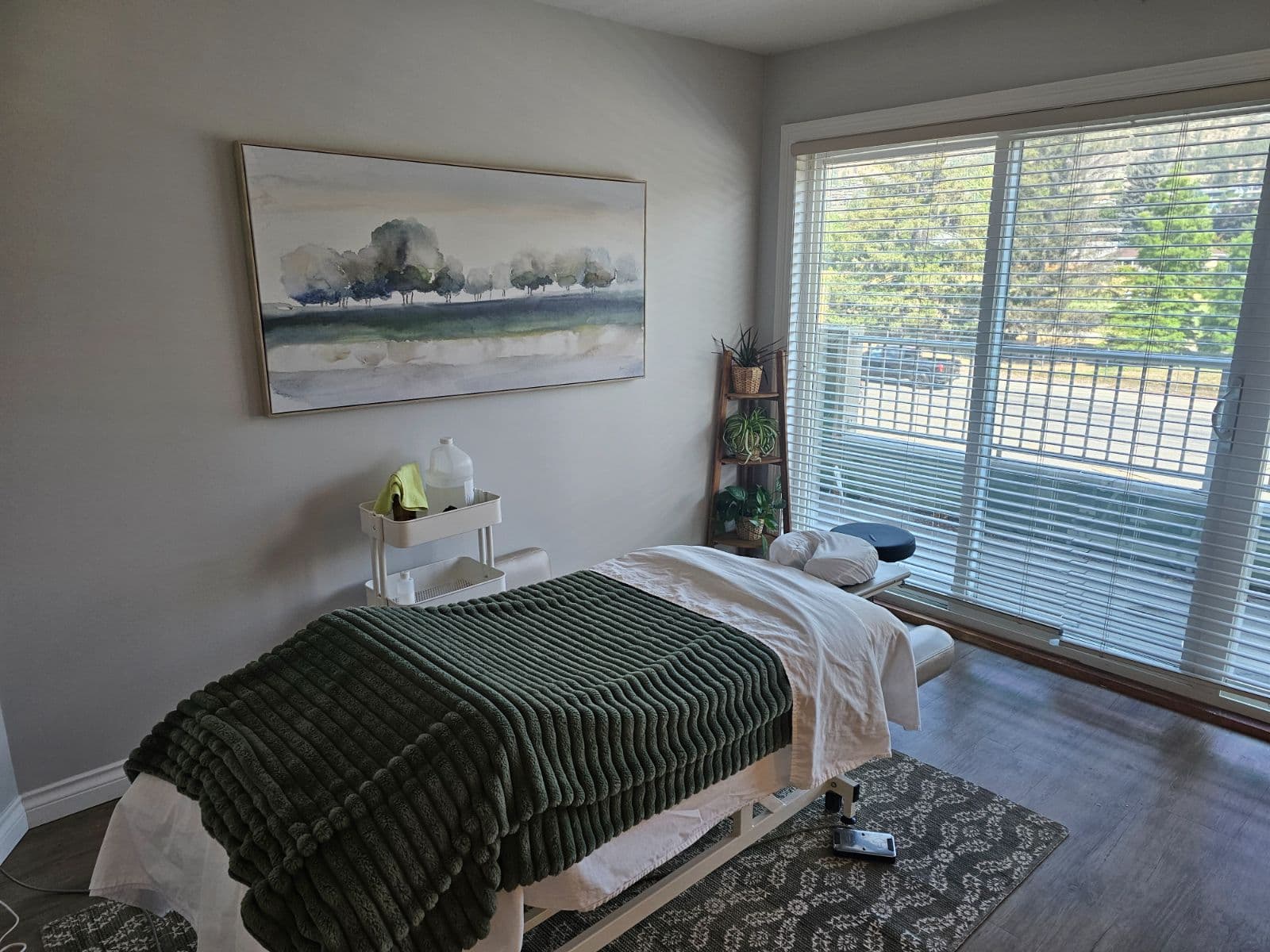 A prepared treatment table beside a bright window at Back in Health